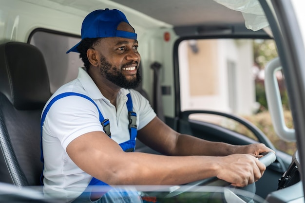 smiling man mover worker blue uniform driving truck delivery moving house service 34755 1433