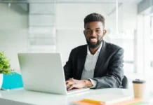 portrait handsome african black young business man working laptop office desk 231208 680jpg