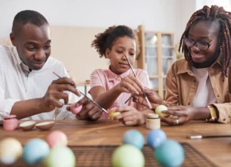 portrait happy african american family painting easter eggs together while sitting wooden table cozy home interior diy easter decorations 236854 28856.jpg