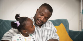 Father and daughter playing keyboard