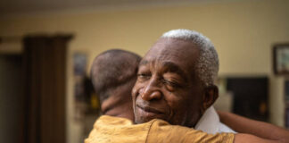 Bonding moment of father and son embracing and giving emotional support at home