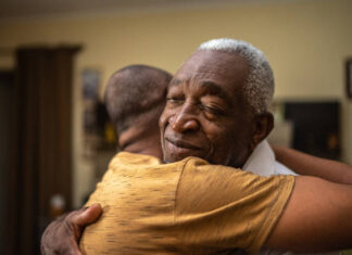 Bonding moment of father and son embracing and giving emotional support at home