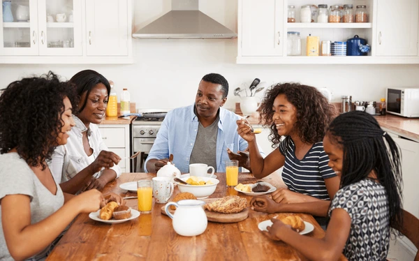 family teenage children eating breakfast 600nw 714537895.jpg
