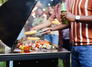 Close up picture of people preparing barbecue on a grill
