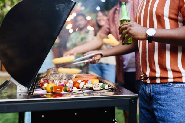 Close up picture of people preparing barbecue on a grill