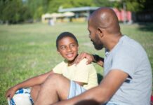 close up happy african american dad talking his son handsome