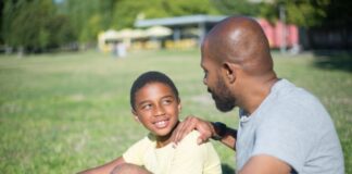 close up happy african american dad talking his son handsome