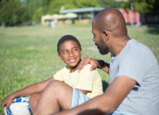 close up happy african american dad talking his son handsome