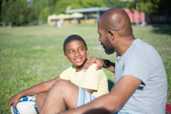 close up happy african american dad talking his son handsome