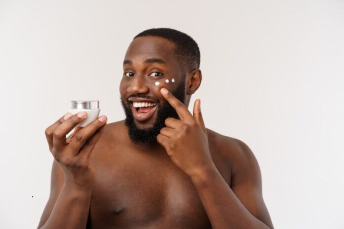 handsome man applying cream