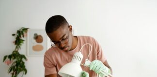 man repairing lamp
