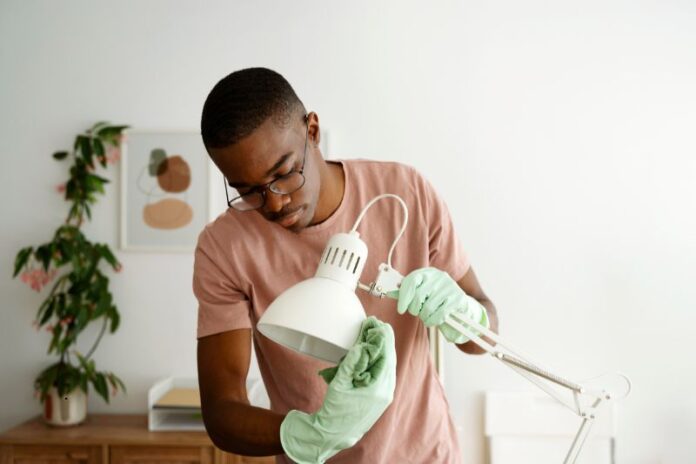 man repairing lamp