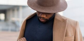 stylish man posing mysterious way while looking his watch (1)