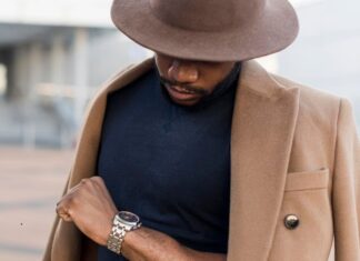 stylish man posing mysterious way while looking his watch (1)