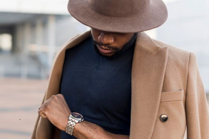 stylish man posing mysterious way while looking his watch (1)